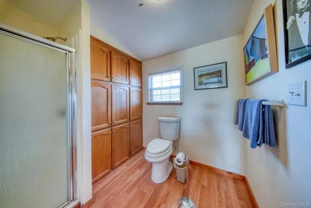 a view of a roof deck with table and chairs wooden floor and fence