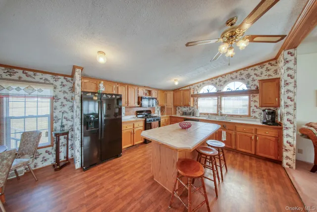 a kitchen with stainless steel appliances granite countertop a stove a refrigerator and a sink