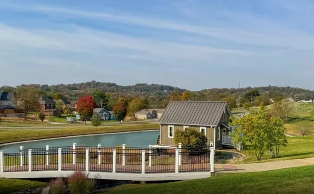 a view of a city with tall buildings and a big yard with swimming pool and mountain view