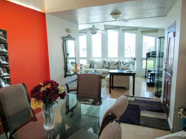 a living room with furniture and a floor to ceiling window