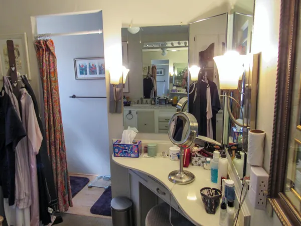 a view of walk in closet with clothes and shoes