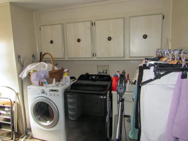 a view of a storage and utility room with washer and dryer