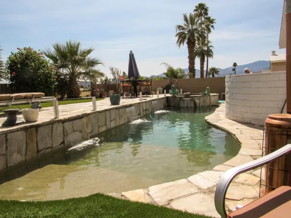 a view of swimming pool with a table and chairs