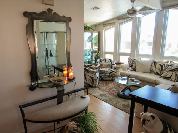 a living room with furniture and a mirror