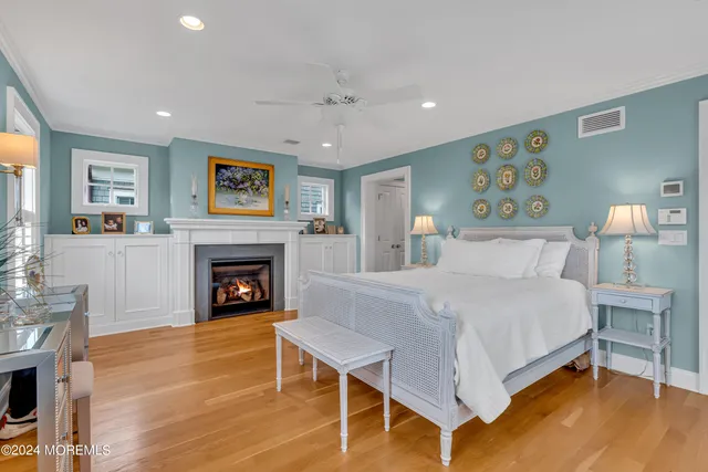 a bedroom with a bed a chandelier and a window