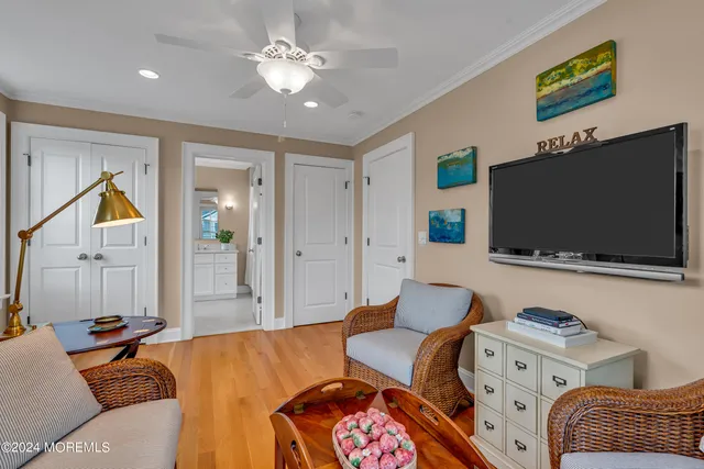 a bedroom with a bed a dresser and next to a window