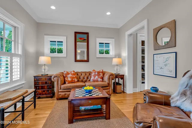 a living room with furniture a rug and a window