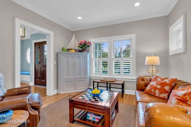 a living room with furniture a chandelier and a table