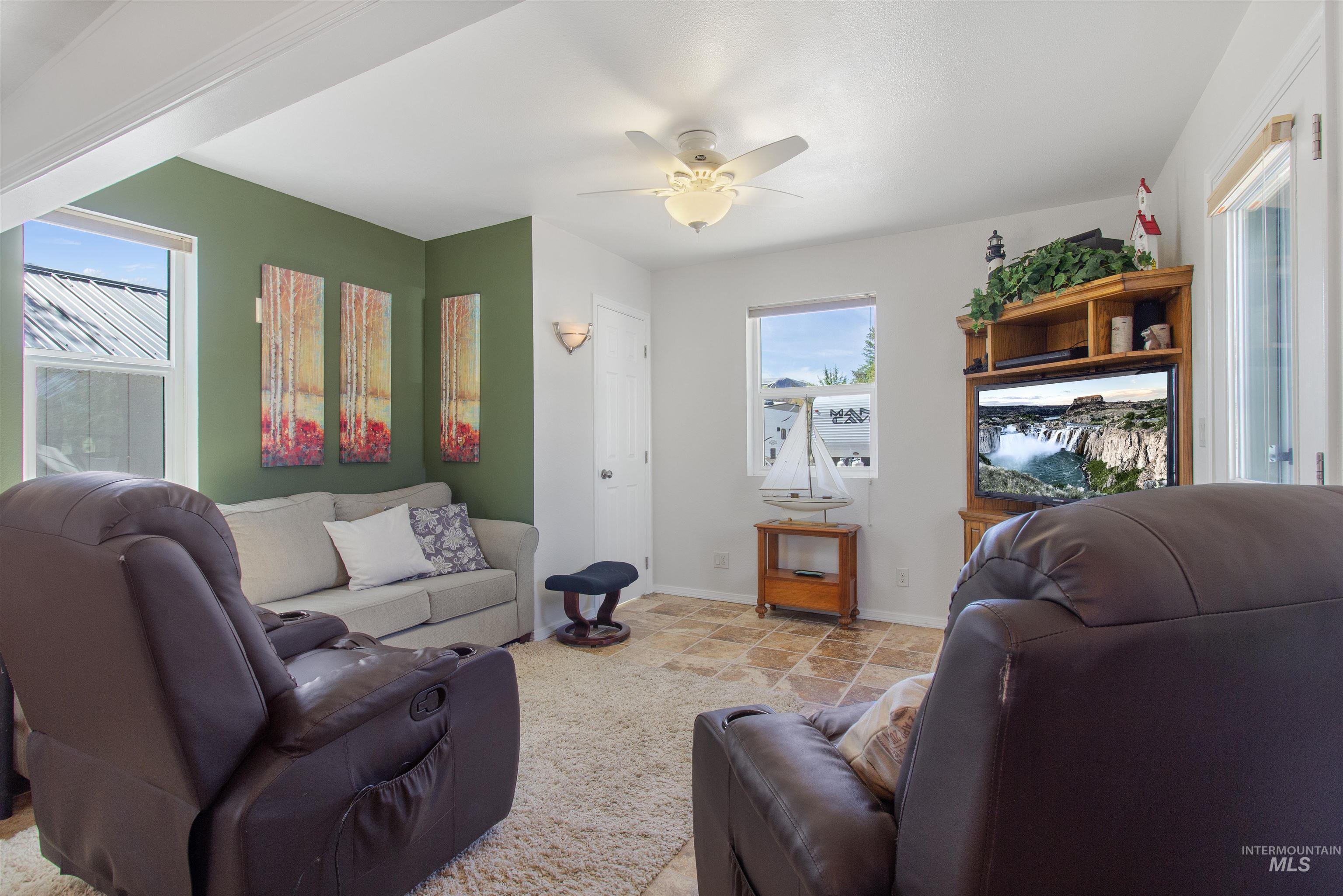 106 West Magic Road Shoshone, ID 83352 - Photo 9 of 45 Living area featuring painted walls and a ceiling fan with integrated lighting