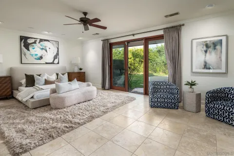 a bedroom with a bed and glass door