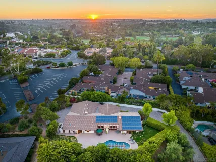 an aerial view of a house with a mountain in the background