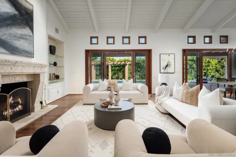 a living room with furniture fireplace and window