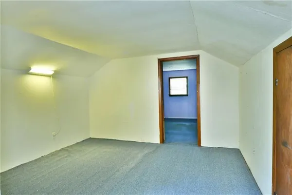 a view of an empty room with a bathroom