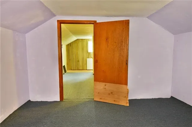 an empty room with wooden floor and a door