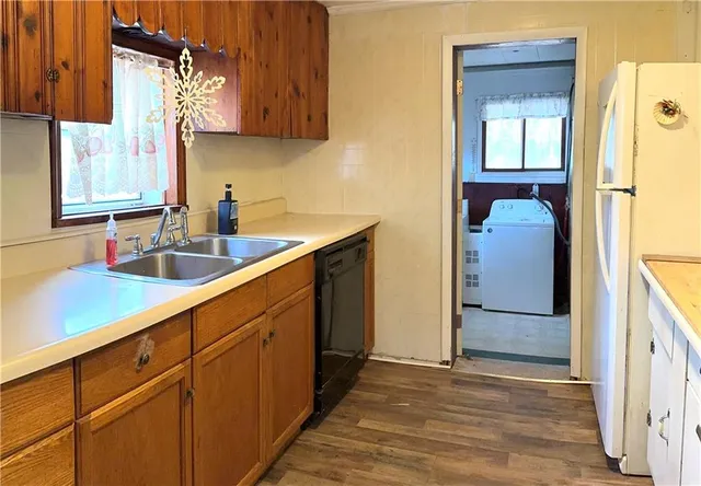 a kitchen with a sink and a refrigerator