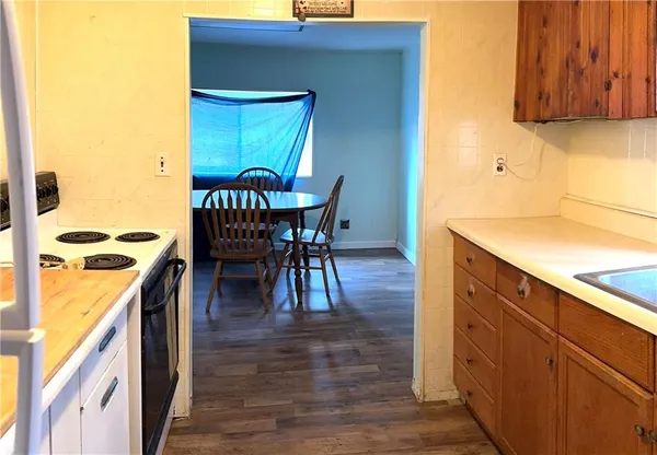 a dining room with furniture and wooden floor