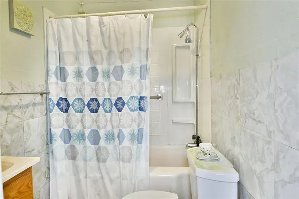 a bathroom with a shower curtain and a curtain