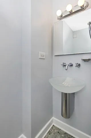 a bathroom with a sink and mirror