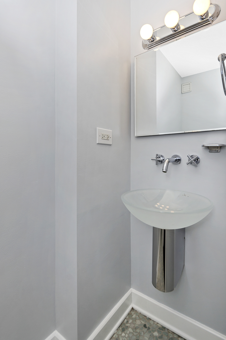 30 East Huron Street, Unit 3602 Chicago, IL 60611 - Photo 14 of 15 a bathroom with a sink and mirror