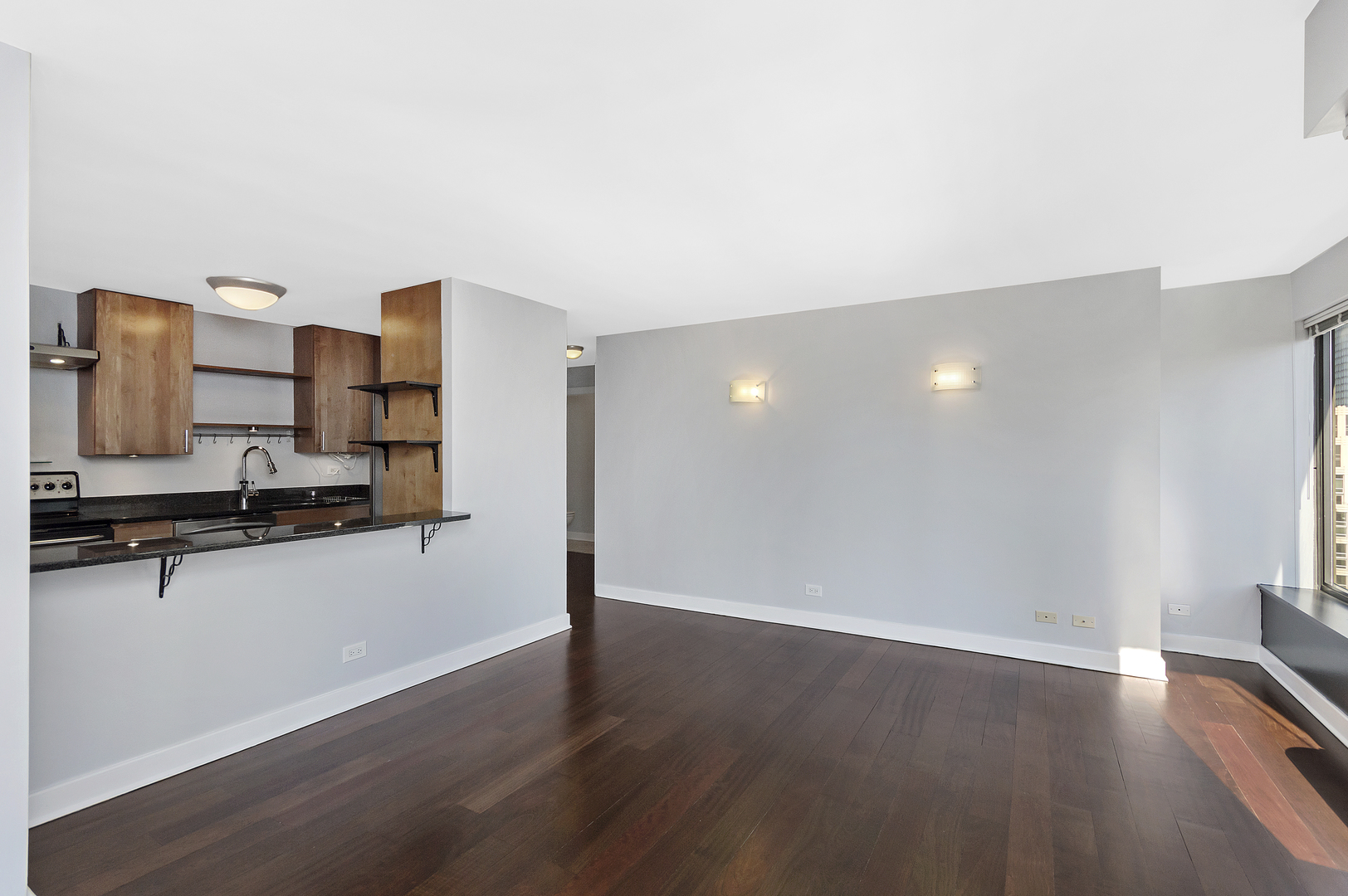 30 East Huron Street, Unit 3602 Chicago, IL 60611 - Photo 5 of 15 a view of a room with wooden floor and cabinet