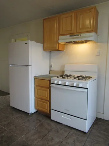 a stove top oven sitting inside of a kitchen
