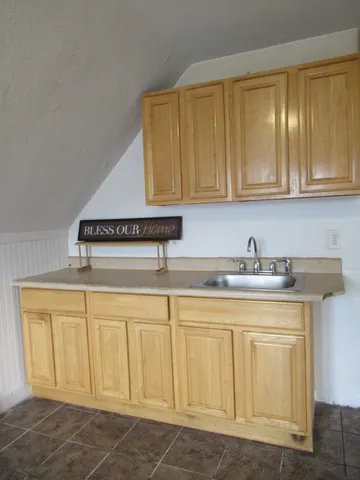 a kitchen with white cabinets and a sink
