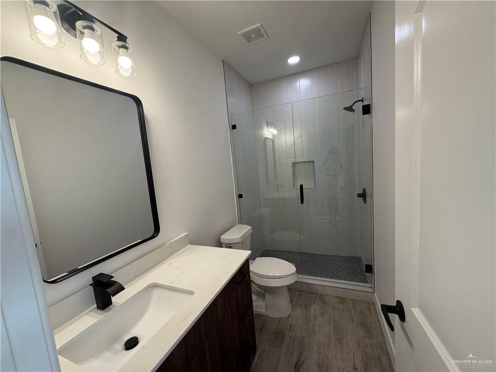2701 Brownjay Road, Unit #3 Weslaco, TX 78596 - Photo 11 of 18 a bathroom with a sink a toilet a mirror and shower