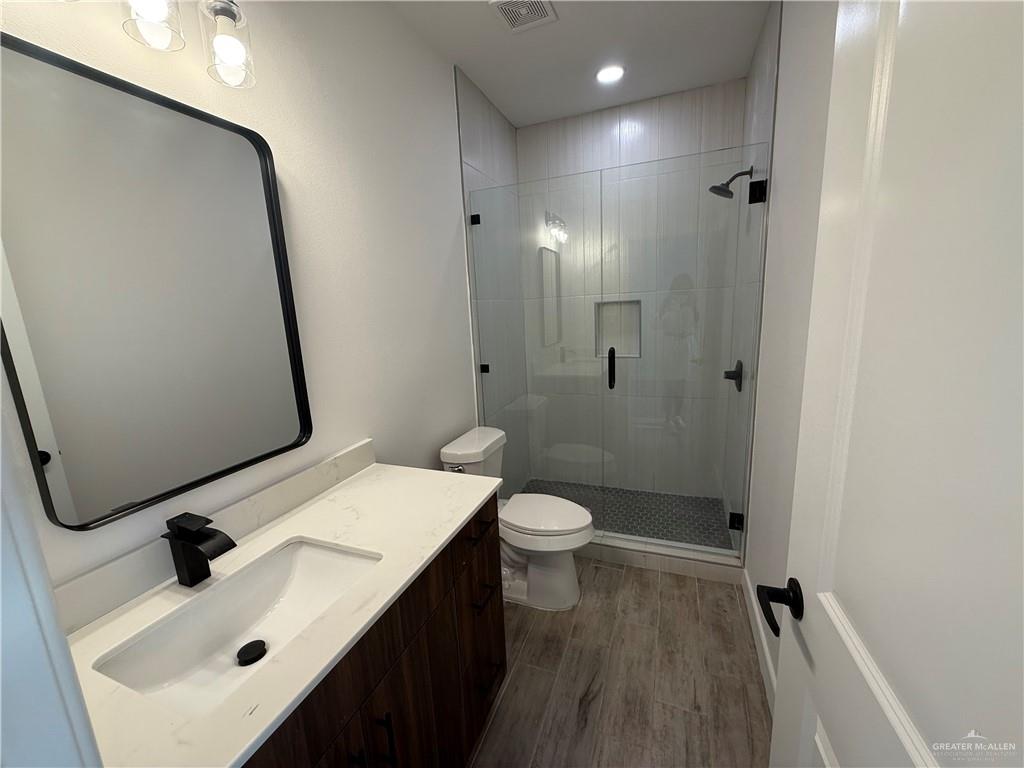 2701 Brownjay Road, Unit #3 Weslaco, TX 78596 - Photo 13 of 18 a bathroom with a sink a toilet and shower