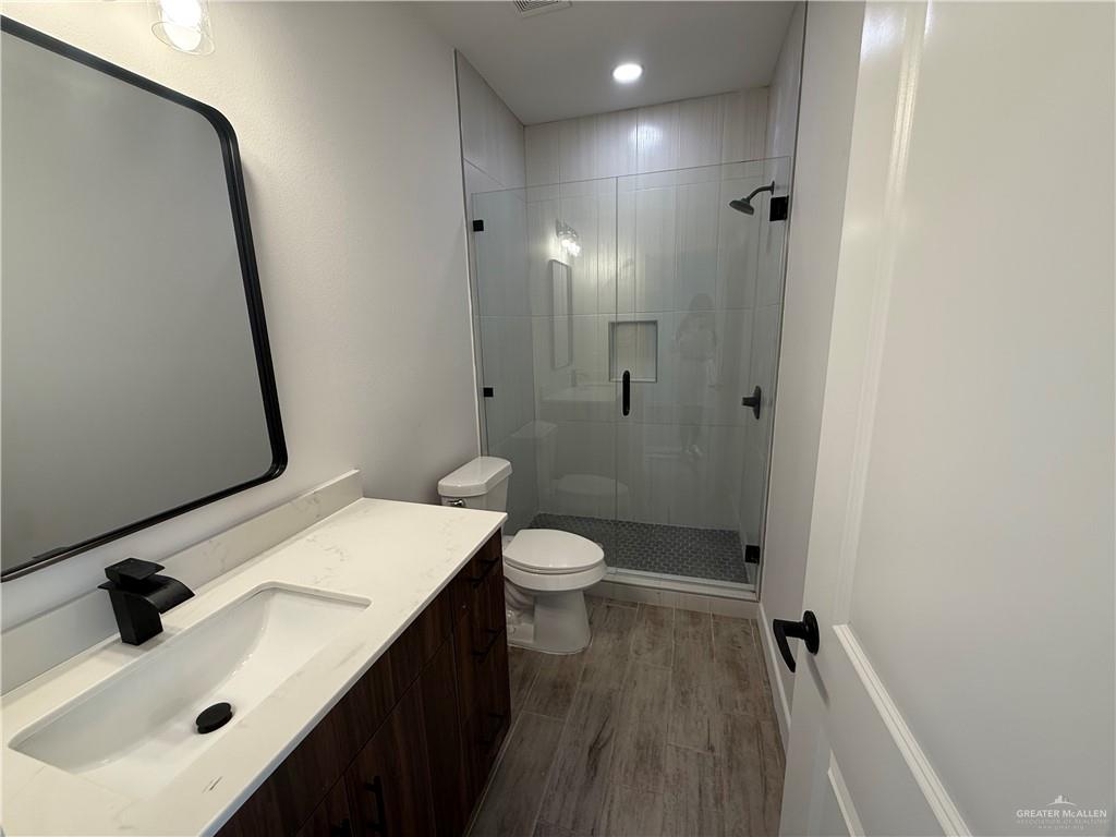 2701 Brownjay Road, Unit #3 Weslaco, TX 78596 - Photo 14 of 18 a bathroom with a sink a toilet and shower