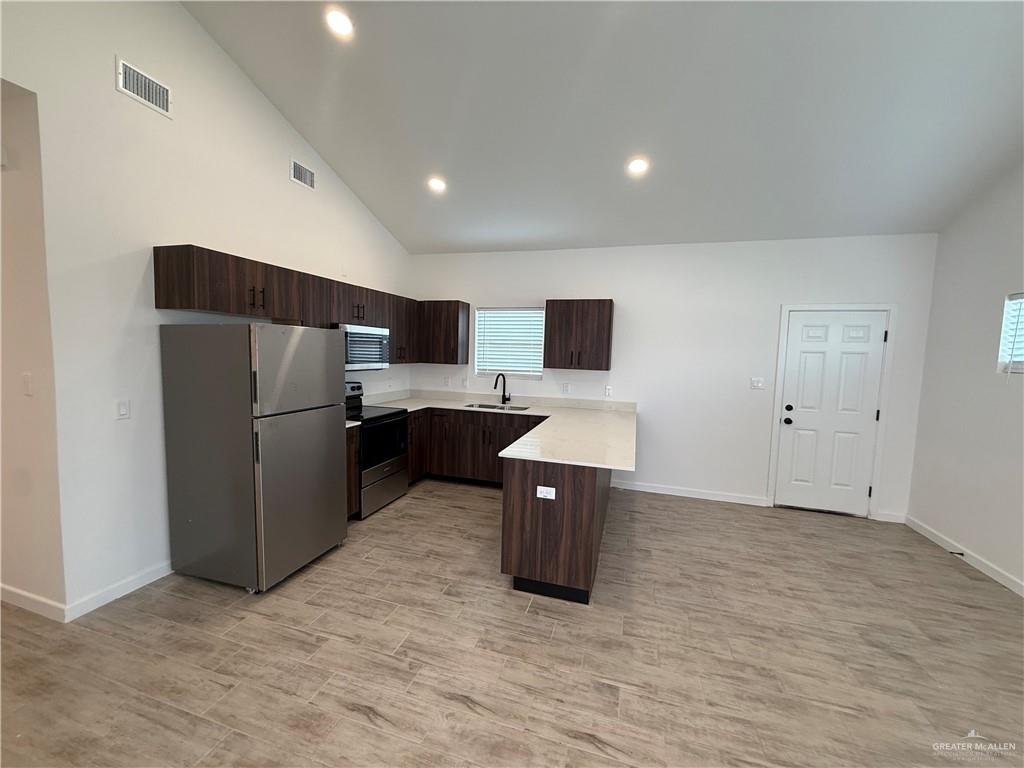 2701 Brownjay Road, Unit #3 Weslaco, TX 78596 - Photo 2 of 18 a kitchen with stainless steel appliances a refrigerator and a microwave