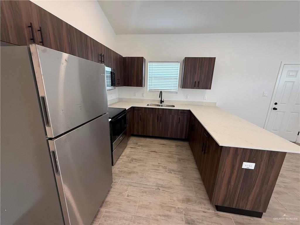 2701 Brownjay Road, Unit #3 Weslaco, TX 78596 - Photo 3 of 18 a kitchen with stainless steel appliances a refrigerator and a sink