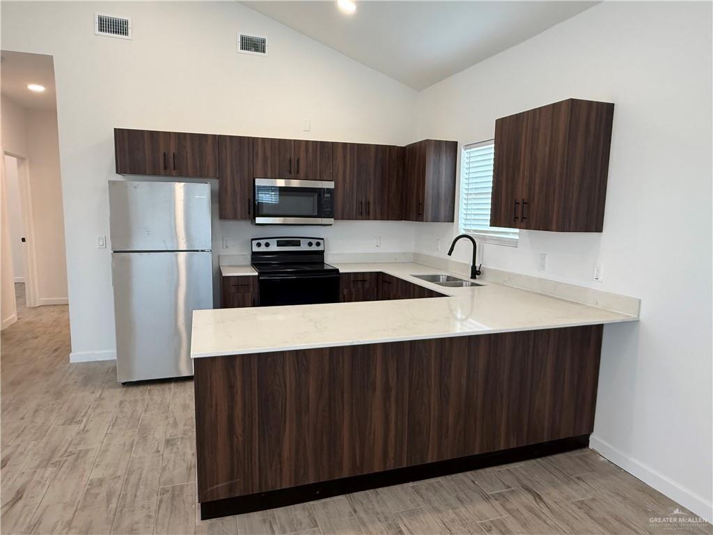 2701 Brownjay Road, Unit #3 Weslaco, TX 78596 - Photo 5 of 18 a kitchen with stainless steel appliances a refrigerator and a sink