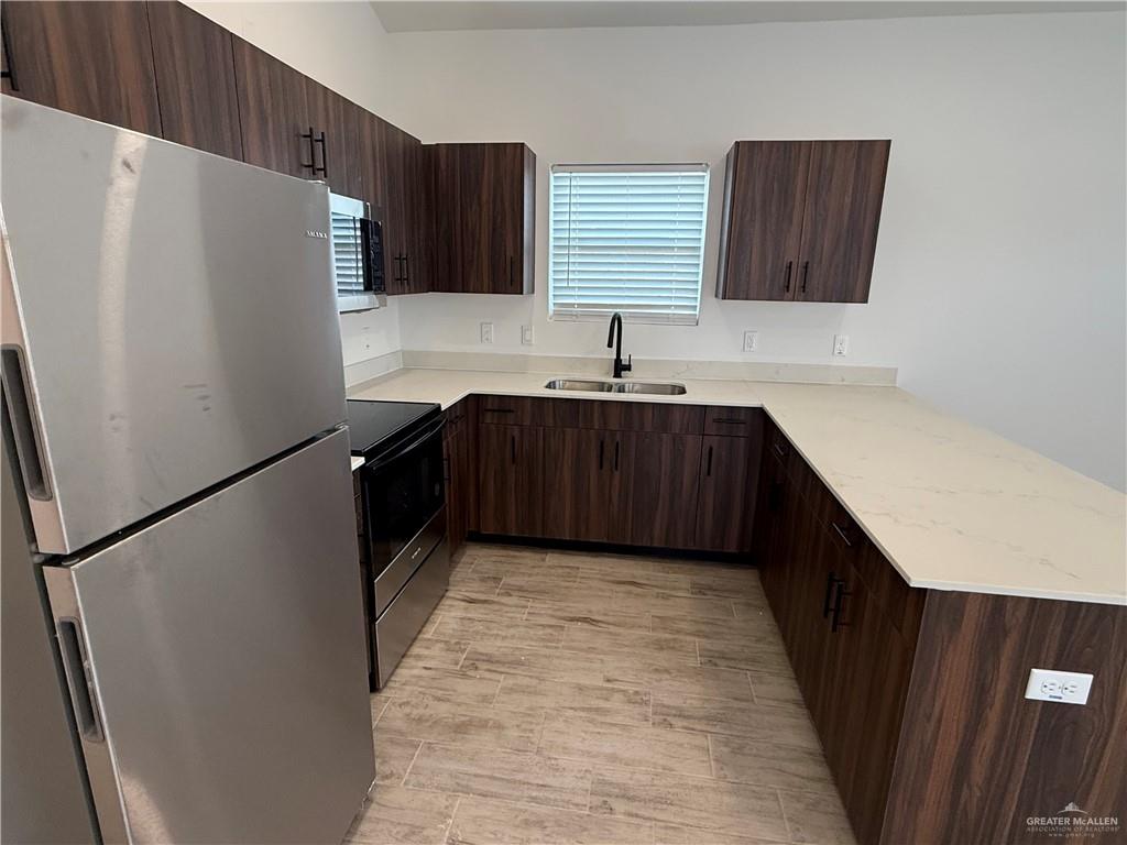 2701 Brownjay Road, Unit #3 Weslaco, TX 78596 - Photo 6 of 18 a kitchen with stainless steel appliances a refrigerator and a sink