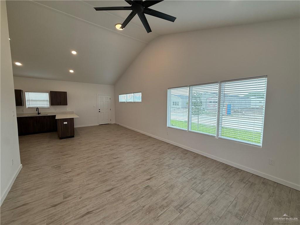 2701 Brownjay Road, Unit #3 Weslaco, TX 78596 - Photo 8 of 18 a view of an empty room with a window and a kitchen