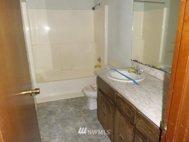 578 Brown Road East Chehalis, WA 98532 - Photo 14 of 16 a bathroom with a granite countertop sink a toilet and shower