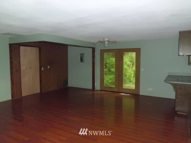 578 Brown Road East Chehalis, WA 98532 - Photo 8 of 16 a view of an empty room with wooden floor and a window
