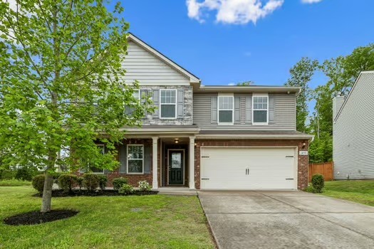 1470 Old Stone Road Lebanon, TN 37087 - Photo 1 of 23 a front view of a house with a garden and yard