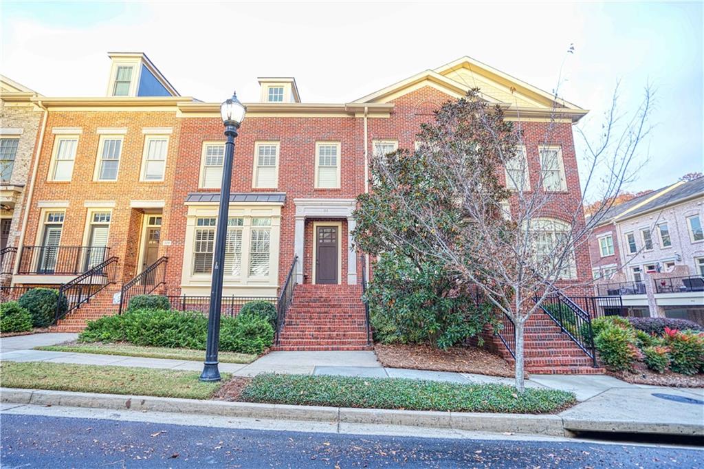 211 Riversgate Drive Atlanta, GA 30339 - Photo 1 of 1 a front view of a multi story residential apartment building with yard and traffic signal