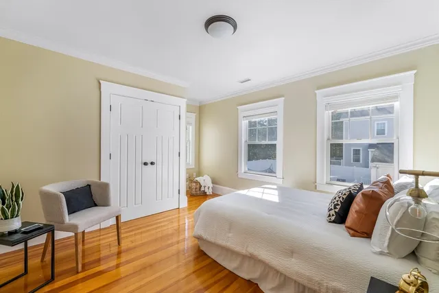 a bedroom with a bed and a chair