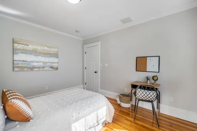 a bedroom with a bed and a lamp