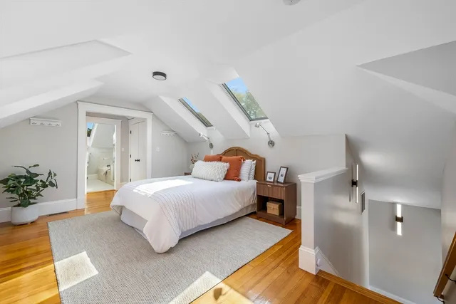a spacious bedroom with a bed and a potted plant