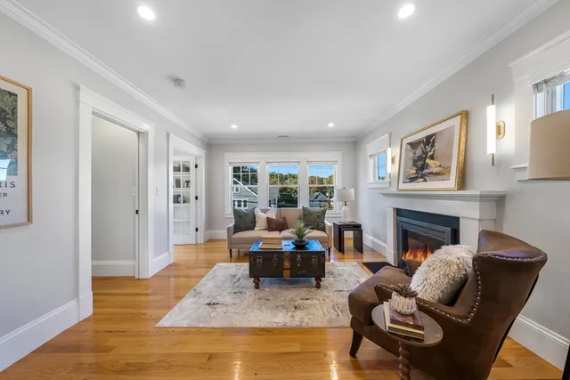 a living room with furniture fireplace and window