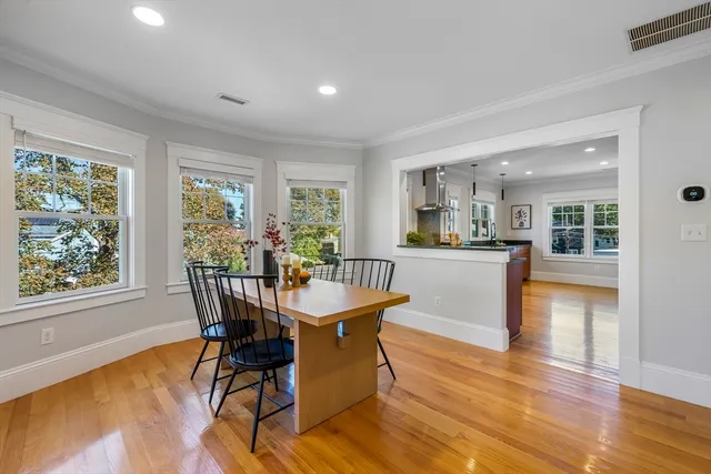 a dining room with furniture and wooden floor