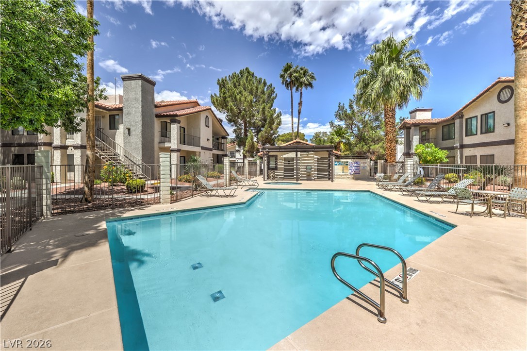 1575 West Warm Springs Road, Unit 322 Henderson, NV 89014 - Photo 25 of 25 This community pool area offers relaxation and recreation under clear skies.