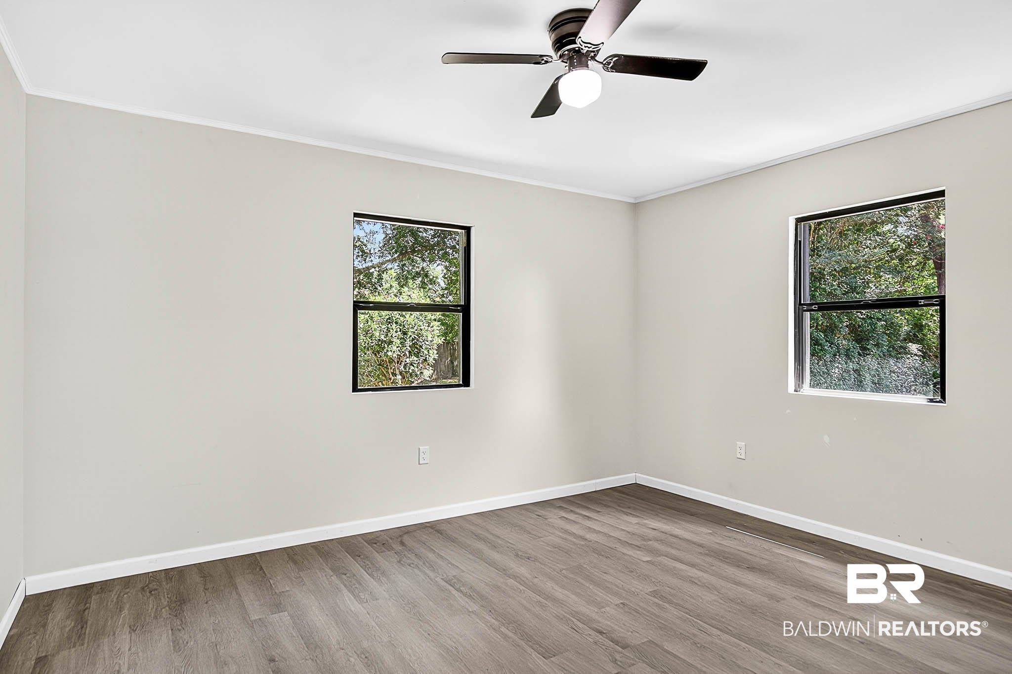 101 Terry Avenue Brewton, AL 36426 - Photo 46 of 48 Empty room featuring wood finished floors, ornamental molding, and ceiling fan