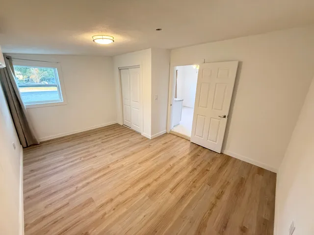 wooden floor in an empty room with a window