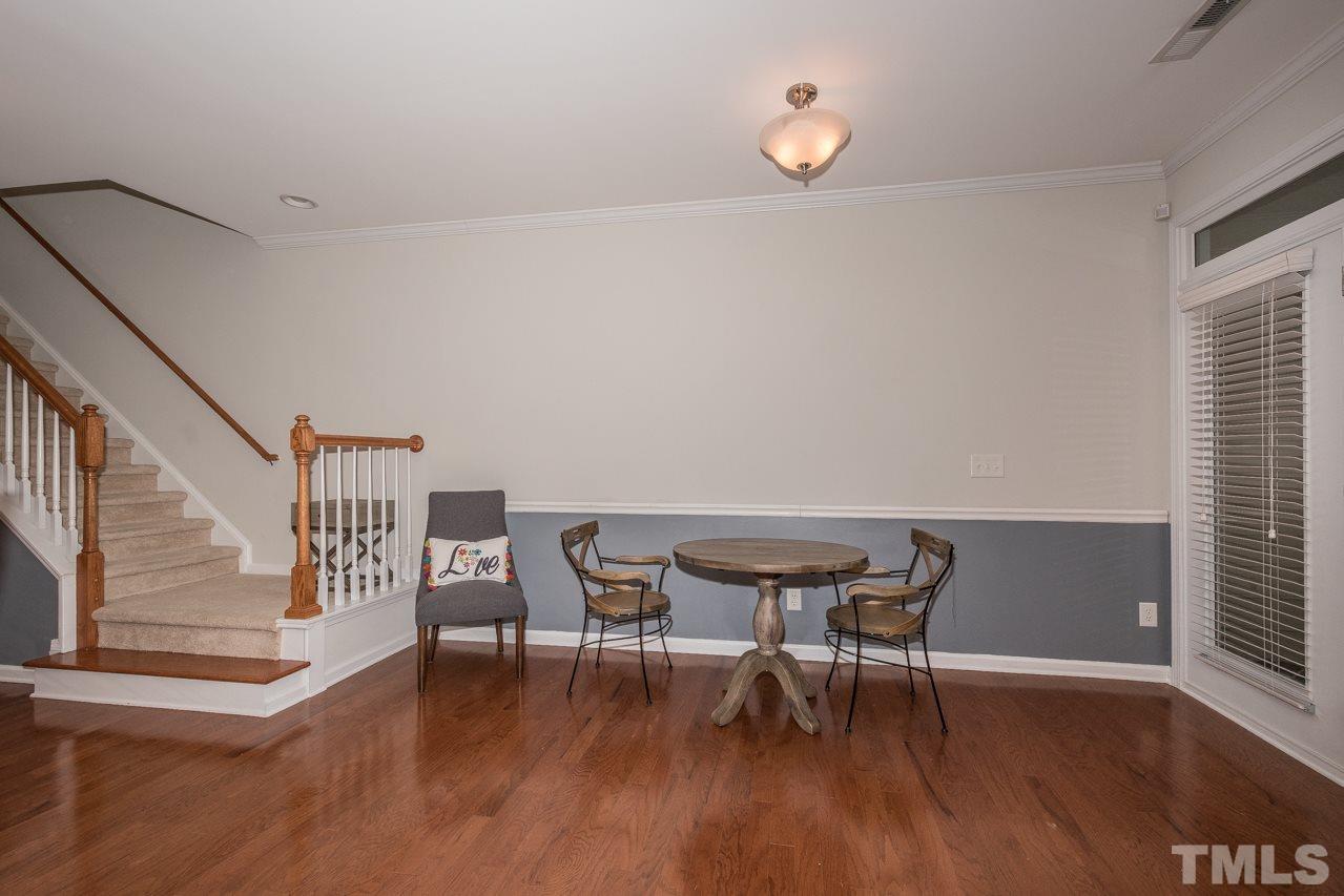 4924 Amber Clay Lane Raleigh, NC 27612 - Photo 14 of 24 a view of a dining room with furniture and wooden floor