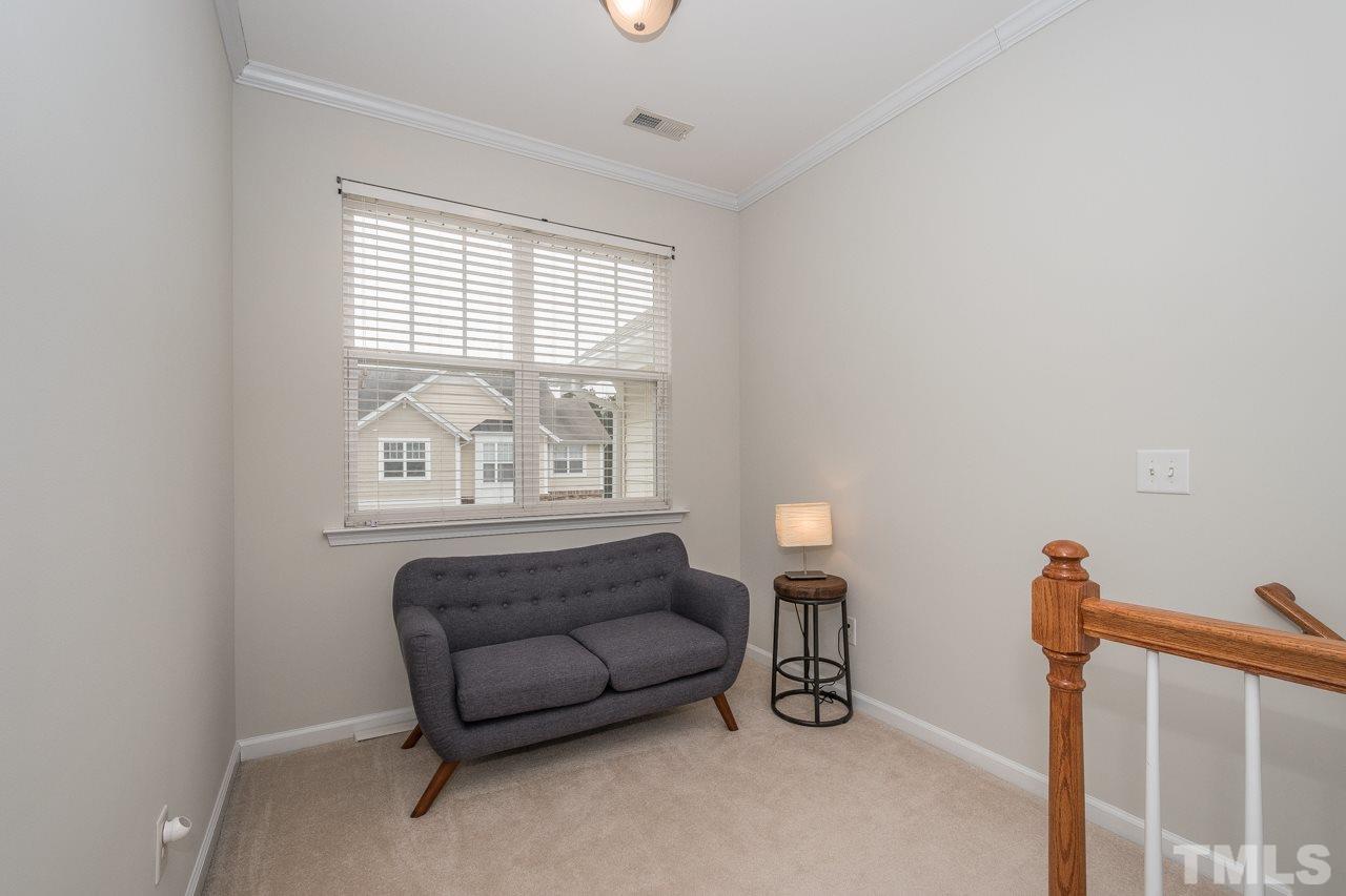4924 Amber Clay Lane Raleigh, NC 27612 - Photo 16 of 24 a living room with furniture and a window