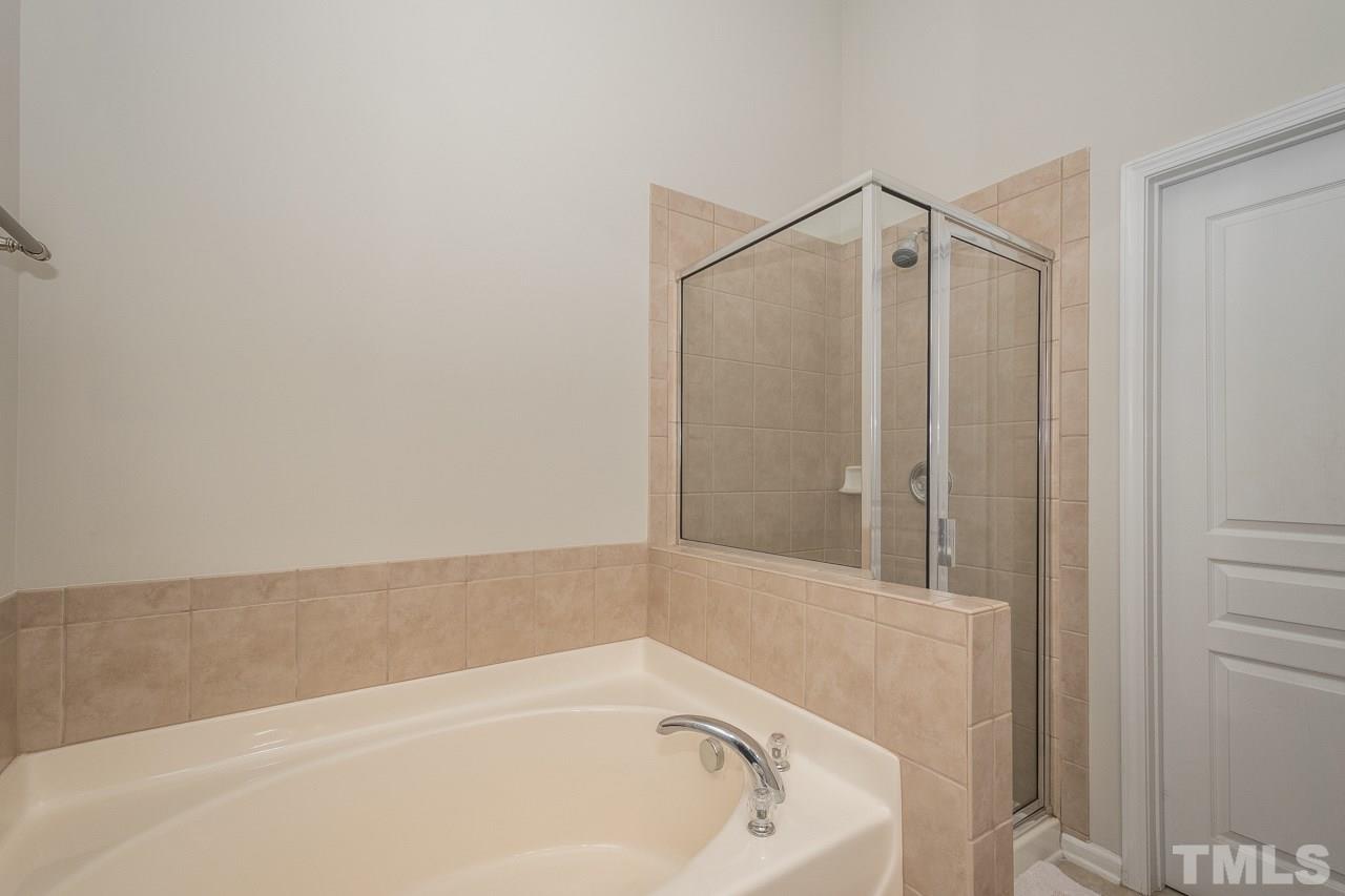 4924 Amber Clay Lane Raleigh, NC 27612 - Photo 19 of 24 a bathroom with a bathtub and a shower