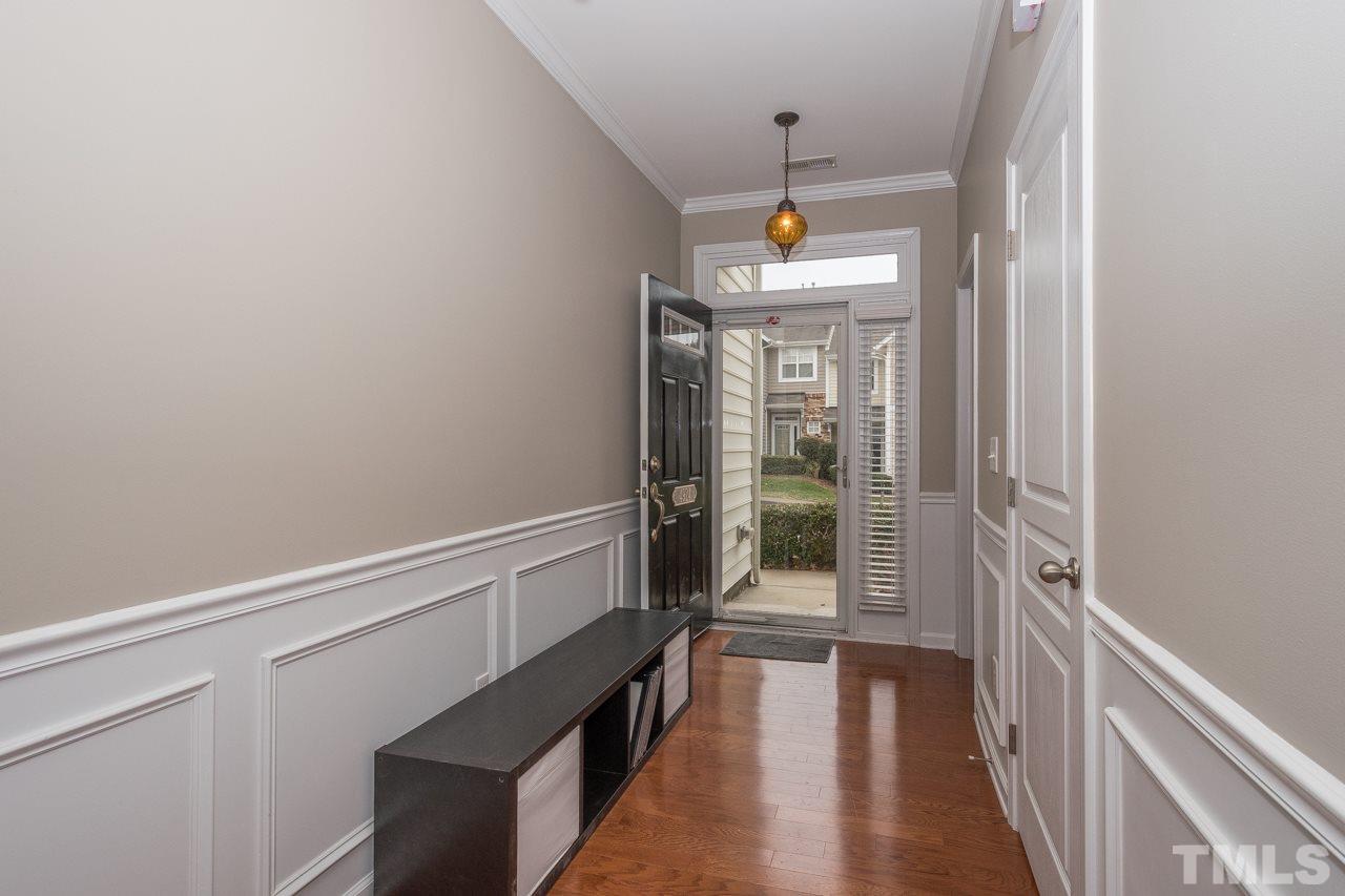 4924 Amber Clay Lane Raleigh, NC 27612 - Photo 3 of 24 a view of a hallway with wooden floor and staircase